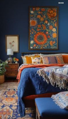 a bedroom with blue walls and an orange bed