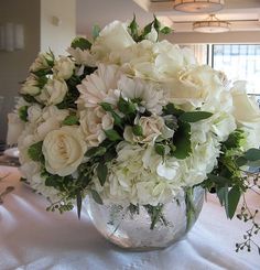 a vase filled with white flowers on top of a table