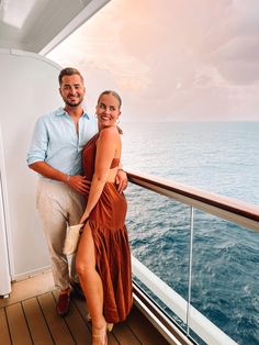 a man and woman standing on the deck of a ship