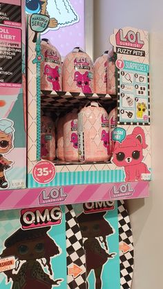 an assortment of lol surprises on display in a toy store shelf with stickers