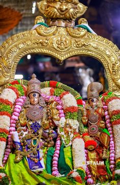 an elaborately decorated statue in front of a mirror