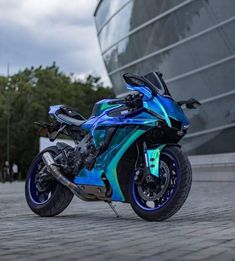 a blue motorcycle parked in front of a building