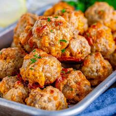 meatballs with cheese and sauce in a metal pan