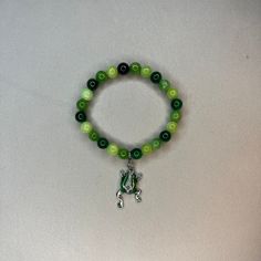 Super cute green beaded bracelet with a frog charm Cheap Green Novelty Bracelets, Green Hand-strung Bracelets For Friendship, Green Bracelets For Friendship, Green Hand-strung Jewelry For Friendship, Green Spiritual Charm Bracelet Gift, Spiritual Green Charm Bracelet Gift, Casual Hand-strung Jade Jewelry, Spiritual Green Charm Bracelet For Gift, Casual Green Beaded Bracelets