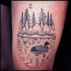 a tattoo on the leg of a person with trees and a duck swimming in water