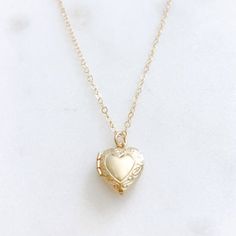 DESCRIPTION: The CHARLOTTE Necklace - Gold Heart Locket on a dainty gold filled chain. We love this sweet little necklace and think you will too! Insert a treasured photo and keep it close to your heart! The cutest way to show your love for someone special!MATERIALS:Chain, Clasp, Jump Rings - Gold Filled  Locket - Gold PlatedPENDANT SIZE:Approximately 1/2” in lengthPACKAGING:Your necklace will arrive on a Dainty Doe signature jewelry card placed in a white jewelry box, with a bow and tag, perfec Dainty Heart Pendant Locket Necklace For Keepsake, Delicate Heart Pendant Locket Necklace, Dainty Locket Necklace For Valentine's Day Anniversary, Dainty Necklace For Valentine's Day Keepsake, Dainty Heart Locket Necklace For Anniversary Gift, Dainty Open Heart Locket Necklace For Keepsake, Dainty Heart Pendant Jewelry With Vintage Charm, Dainty Heart-shaped Keepsake Necklace, Dainty Valentine's Day Keepsake Necklace