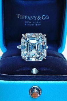 an emerald cut diamond ring in a blue box with the words tiffany & co on it