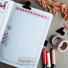 an open notebook with writing on it next to some markers and washi tapes