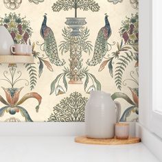 the wall paper has peacocks on it and is next to a potted plant