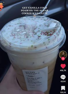 someone holding up a cup of ice cream with sprinkles on it and the text getavallaco foam on the sugar cookie iced latte