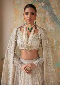 Heavy White Indian Wedding Dress Lehenga Choli is emblazoned in intricate embroidery done on Lehenga choli in the work of kora, dabka, tilla, and sequins which is sure to make you look dazzling on your big day. Choli: Beautiful ornamental motifs are embedded on heavily embellished choli, encrusted on sheer silver embellishments heavily adorned with intricate hand-worked detailing infused with elegance for the maharani look from our bridal collection. This particular pattern merges rich tradition White Indian Wedding Dress, Wedding Dress Lehenga, Dress Lehenga, Nikah Dress, Lehenga Dupatta, Organza Lehenga, White Indian Wedding, Embellished Blouse, Pakistani Bridal Wear