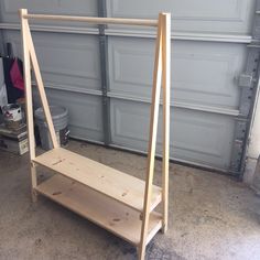 a wooden shelf sitting in front of a garage door