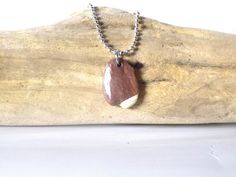 This pendant is made with a Montana river rock. This stone is unique because it looks like it was dipped in white paint. The white is either quartz or quartzite. The entire piece is coated with a gloss sealer to give it a nice sheen and keep it in its wet form. A steel bail was added to stone in order to wear it.  Pendant is shown on a steel ball chain. There is an option at checkout for a black adjustable cord. As with all hand made and painted pieces there is no true "perfection" since they ar Natural Form, Beach Stones, Nature Inspired Jewelry, River Rock, Rock Crafts, Reddish Brown, Inspired Jewelry, Natural Forms, White Paint