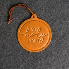 "Celebrate the holidays with this gorgeous O Holy Night Circle Shape Leather Christmas Ornament. Crafted from full-grain leather, this round ornament will delightfully hang from your Christmas tree for years to come. Perfect for personalizing your stocking or use as a gift tag, make this season merry and bright! SPECS     *Dimensions: 4\" wide by 4.4\" tall     *Leather Color Options: Choose from Deep Ocean, Harvest, Black, Stone Natural, Brown, or Sienna     *Made in the USA MATERIALS     *REAL Texas Christmas Decorations, Texas Christmas Decor, Lanyard Bracelet, Leather Christmas, Texas Christmas, Stocking Tags, Laser Ideas, Leather Ideas, O Holy Night