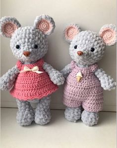 two crocheted teddy bears are standing next to each other