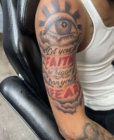 a man with a tattoo on his arm that says, let your faith be bigger than your fear