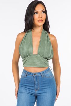 A crop top featuring a back-tie halter strap that crosses at the neck, fitted bodice, cropped length and luxe plisse fabrication.Fabric: 100% Polyester Made in: Los Angeles, USA Size Bust Waist Hips XS 32 24 - 25 33 - 34 S 34 - 35 26 - 27 35 - 36 M 36 - 37 28 - 29 38 - 40 L 38 - 39 30 - 31 42 - 44 V-neck Tie Back Halter Top For Night Out, Fitted Cropped Halter Top For Night Out, Spring Triangle Crop Top For Night Out, V-neck Tie Back Crop Top For Party, Chic Cropped Halter Top For Party, Trendy Triangle Crop Top For Night Out, Chic Halter Neck Crop Top For Spring, Versatile Backless Halter Top With Tie Back, Halter Neck Crop Top For Night Out