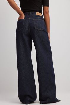 These jeans feature a high waist with a zipper and button closure and a five-pocket design. They have wide legs with decorative seams along each leg. Navy Jeans Outfit, Jeans Trousers Women, Moodboard Fashion, Fw 2024, Decorative Seams, Wide Leg Denim Jeans, Trousers Women Wide Leg, Outfits Female, Buying Stuff