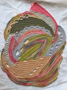 a crocheted doily with many different colors