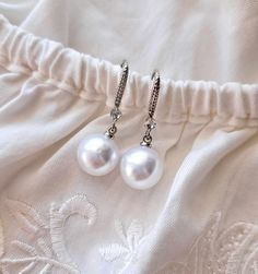 This Bridal Pearls Earrings,a beautiful and delicate bridal accessory for brides.  On the wedding day, every bride wants to look fantastic. This delicate earrings pearls will be a magical addition to your look on your happiest day.  This will emphasize the ease and sophistication of your image.  -Material- simulated pearl   -Colors- white and silver  - Unique handmade.  Wedding - is one of the Wedding Drop Earrings, Round Pearl Earrings, Silver Bridal Earrings, Drop Earrings Silver, Bridal Accessory, Pearls Earrings, Wedding Earrings Drop, Bridal Earrings Pearl, Earrings Round