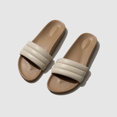 Inspired by the fantasy of a summer day, SHELL is a reminder of a simpler time foraging for seashells on the beach, and the sheer pleasure of the bounty collected by sunset. Featuring a dense, sculpted foam sole, our Sandalias are expertly crafted and sophisticatedly wrapped in soft, high quality lambskin.  While our S Beige Closed Toe Slides For Beach, Beige Closed-toe Slides For The Beach, Beige Closed Toe Slides For The Beach, Cream Slip-on Slides For The Beach, Cream Open Toe Slides For Beach, Beige Beach Slides With Rubber Sole, Cream Sandals With Rubber Sole For Beach, Beige Slides With Textured Sole For Beach, Seashells On The Beach