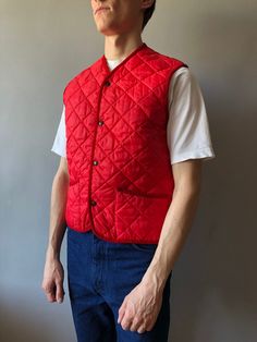 Quilted Waistcoat / Quilted Vest / Size M / 1990s  This vintage quilted vest wonderful condition! - made in Italy - ERA - circa 1990's - color - red - 2 outside pockets - 4 stud buttons at front - material - 100% polyester - label size - M (watch measurements) FLAT Measurements: Shoulders: 39cm Chest (underarm to underarm): 50cm Length(back): 62cm Pay your attention to that  most antique items have been used and may have minor flaws. Please , read the description carefully and check the measurem Casual Quilted Cotton Vest, Vintage Spring Vest Outerwear, Vintage Quilted Cotton Outerwear, Vintage Winter Vest Outerwear, Classic Red Winter Vest, Winter Quilted Cotton Vest, Vintage Quilted Jacket With Pockets For Fall, Quilted Vest For Winter Streetwear, Vintage Sleeveless Winter Outerwear