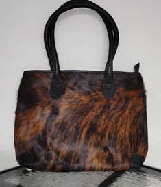 A double sided cowhide hairon leather bag adds an extra elegance to the style. Shiny cowhide fur/hairon leather tote is large enough to pack your daily travel items. I has a dedicated tab and laptop compartment too. *Dimentions Length 41cm× Height 30cm ×Width 8cm * Main Zipper Compartment, Internal Zipper, Ipad/Tab Compartment and 2 small open pockets/organizers. Cowhide Leather Purse, Leather And Cowhide Purses, Cowhide Tote Handbags, Leather Cow Print Bag For Everyday Use, Louis Vuitton Flower Mm Monogram Canvas & Cowhide Leather Zipped Tote Noir, Pocket Organizer, Travel Items, Double Face, Leather Tote