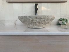 a bowl shaped sink sitting on top of a counter