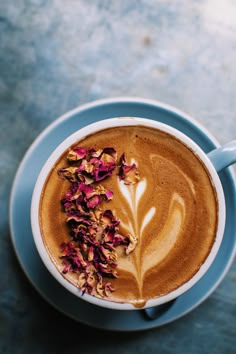 a cappuccino with flowers in it on a saucer