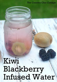 kiwi blackberry infused water in a mason jar with blackberries on the table next to it