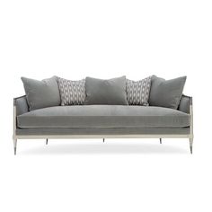 a gray couch with four pillows on it