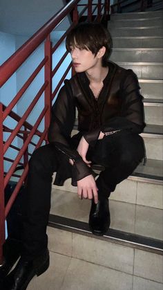 a woman sitting on some stairs with her hand in her pockets and wearing black boots