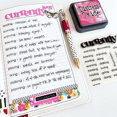 a notebook with some writing on it next to a stamp pad and pen, which is also filled with stickers