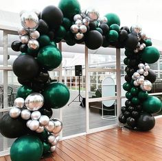 an arch made out of balloons on a deck