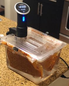 a blender sitting on top of a counter next to a microwave oven with thermometer in it