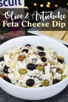 olives and artichoke feta cheese dip in a white bowl