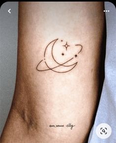 a person with a small tattoo on their arm that has the moon and stars in it