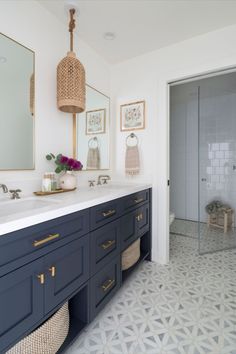 a bathroom with blue cabinets and white walls