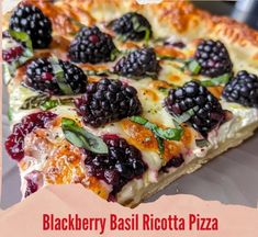 there is a blackberry basil ricotta pizza on the plate