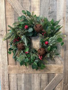 a christmas wreath hanging on the side of a wooden door