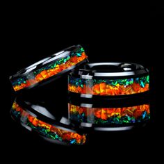 two bracelets that have been made out of glass and are decorated with multicolored stones