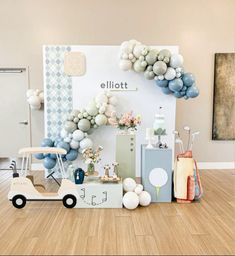 a baby shower with balloons and decorations on the floor in front of a sign that says ellilott