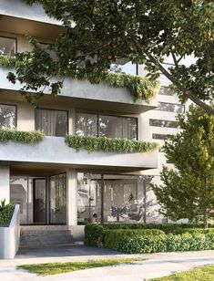 an apartment building with plants on the balconies and trees in front of it