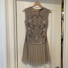 Brand New With Tags Taupe Dress With Bead Embellishments Size Small / Sleeveless Zips Up Back Armpit To Armpit / 16 In. Length From Shoulder To Bottom 33 In. Sleeveless Beige Mini Dress With Sequins, Beige Sleeveless Sequin Mini Dress, Beige Sequined Sleeveless Mini Dress, Beige Sleeveless Mini Dress With Sequins, Fitted Embellished Beige Mini Dress, Chic Sleeveless Beaded Dresses, Chic Beaded Mini Dress For Summer, Elegant Beaded Mini Dress For Summer, Chiffon Wrap Dress