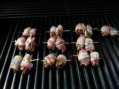 several skewered meats and vegetables on a grill