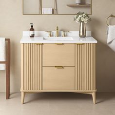 a bathroom vanity with two sinks and mirrors