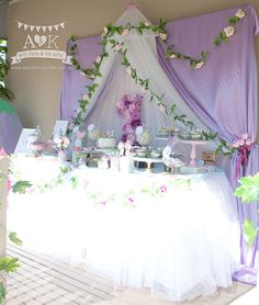 a table covered in purple and white decorations