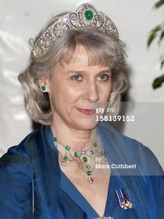 an older woman wearing a tiara and necklace