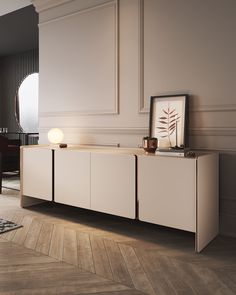 a white sideboard with two lights on it