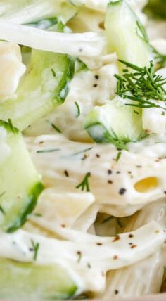 a pasta salad with cucumbers and dill in it is ready to be eaten